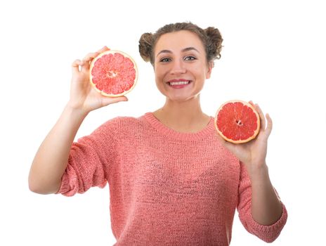 young girl holding fresh grapefruits on a white background
