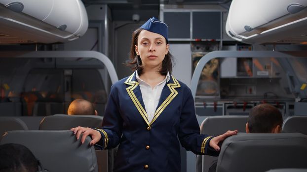 Portrait of woman stewardess in aviation uniform boarding people