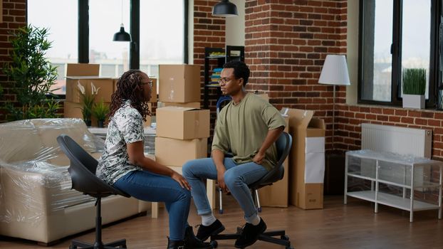 Frustrated couple having argument about real estate decoration