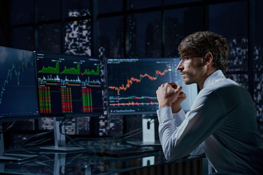 business man looking at the charts of the stock market of cryptocurrencies on the PC screen.