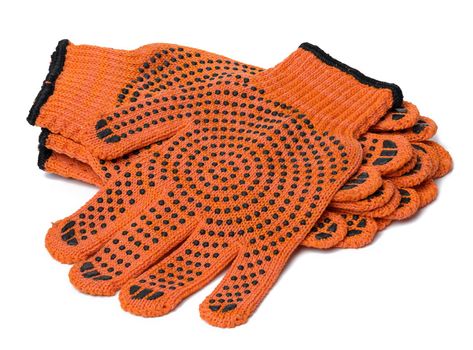 Textile orange work gloves on a white background. Protective clothing 
