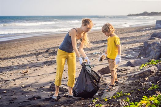 Mother and son are cleaning up the beach. Natural education of children