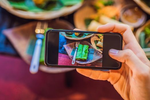 Taking photo of food with smartphone , mobile photographer