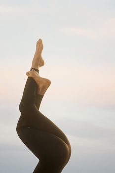 Woman's legs in yoga position in nature.