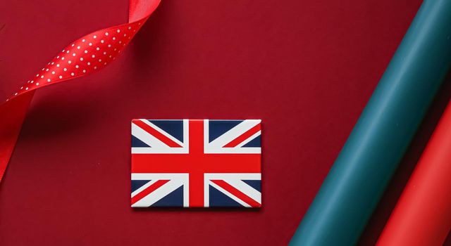 Union Jack flag of Great Britain  on red background, Queen's Platinum Jubilee and holiday celebration