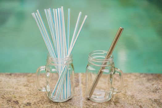 Steel drinking vs disposable straws on pool background. Zero waste concept