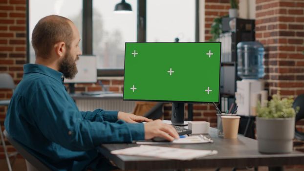 Entrepreneur working with green screen on computer
