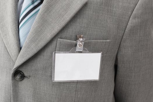 White blank name tag is attached to chest of a businessman .