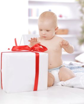 surprised baby playing with gift boxes. photo with copy space