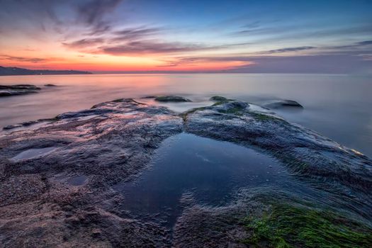 Sea heart. Magnificent sea sunrise at the rocky coast near Varna, Bulgaria