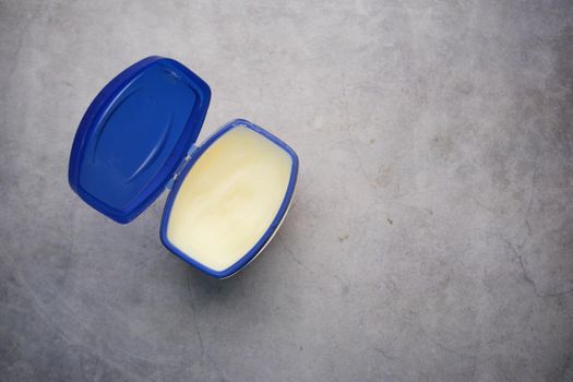 top view of petroleum jelly in a container on black background