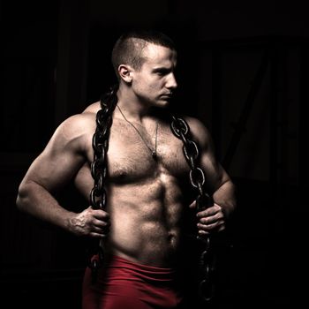 Portrait of a bodybuilder with a chain around his neck