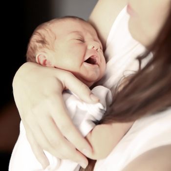 concept of maternal - newborn baby on hands at mum