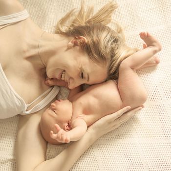 happy motherhood concept - happy mother and newborn baby