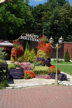 Happy birthday photo area made of natural hay bales painted in different colors