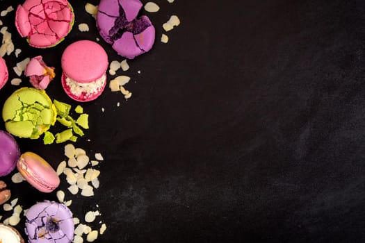 Assorted colorful macaroons on a dark background