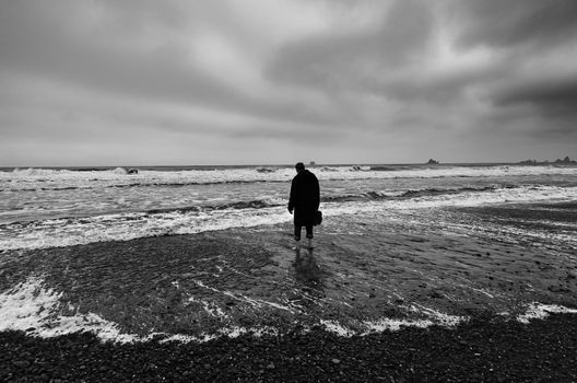 Lonely figure on a stormy beach