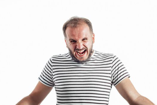 Angry screaming bearded adult rage man in a striped T-shirt. 30-35 years old. Isolated on white.