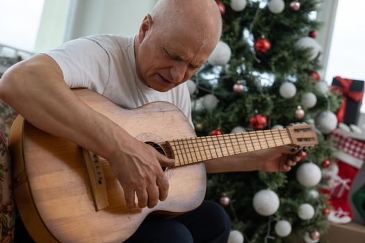 old man with a guitar at christmas