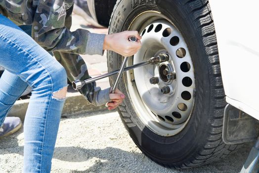 Mechanic replaces the car wheel. car repair garage in your home.