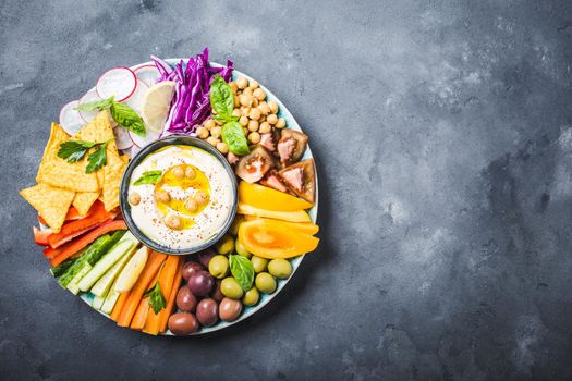 Hummus platter with assorted snacks