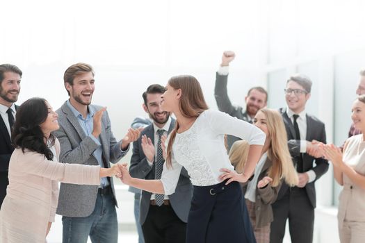happy employees congratulating their leader. the concept of victory
