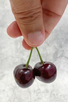 Close up hand held cherries