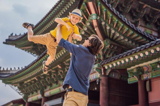 Dad and son tourists in Korea. Gyeongbokgung Palace grounds in Seoul, South Korea. Travel to Korea concept. Traveling with children concept