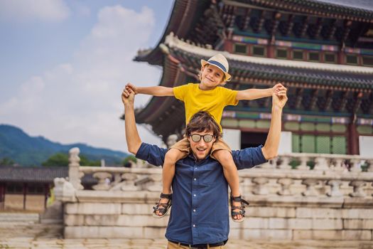 Dad and son tourists in Korea. Gyeongbokgung Palace grounds in Seoul, South Korea. Travel to Korea concept. Traveling with children concept