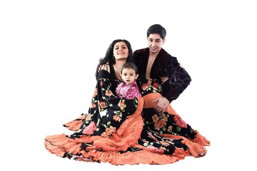 portrait of a happy Gypsy family: father, mother and son in national costumes