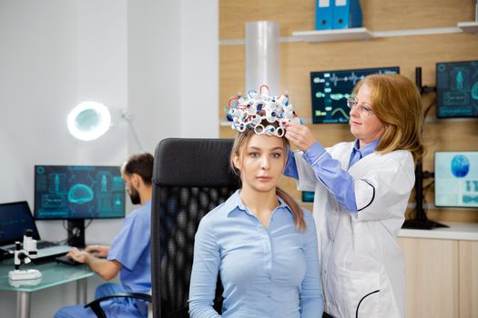 Doctor arranging brain waves scanning headset for a patient