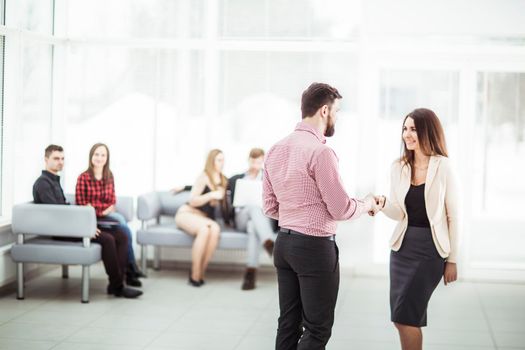 welcome and handshake of business partners in the lobby of the office