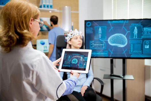 Doctor tracking the evolution of the patient's brain on the tablet