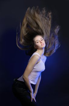 Young woman with hair flying in motion