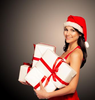 Santa hat Christmas woman holding christmas gifts smiling happy and excited. Cute beautiful multi-racial Caucasian Asian santa girl isolated on black background.