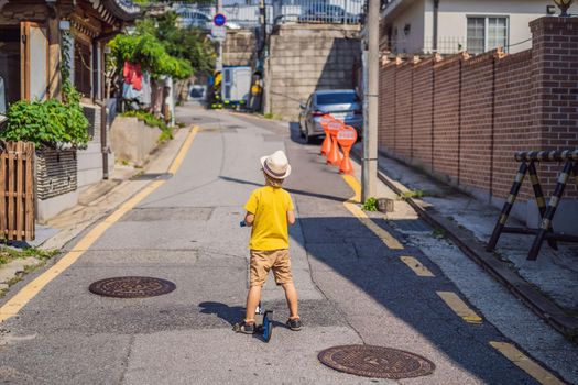 Boy tourist in Bukchon Hanok Village is one of the famous place for Korean traditional houses have been preserved. Travel to Korea Concept. Traveling with children concept