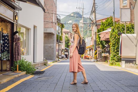 Young woman tourist in Bukchon Hanok Village is one of the famous place for Korean traditional houses have been preserved. Travel to Korea Concept