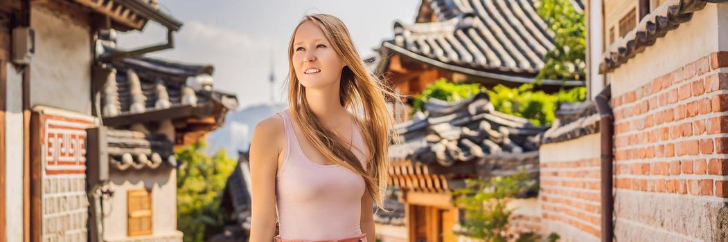Young woman tourist in Bukchon Hanok Village is one of the famous place for Korean traditional houses have been preserved. Travel to Korea Concept BANNER, LONG FORMAT