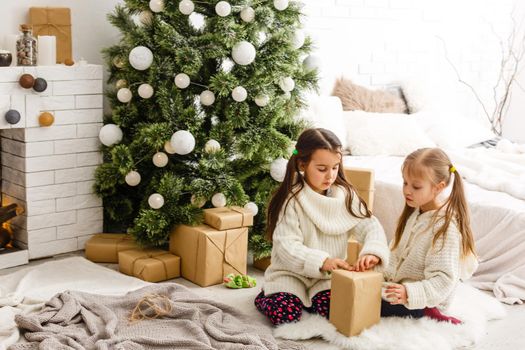 christmas, x-mas, winter, happiness concept - two adorable girls playing