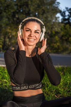 Cute sporty girl listening to music with headphones