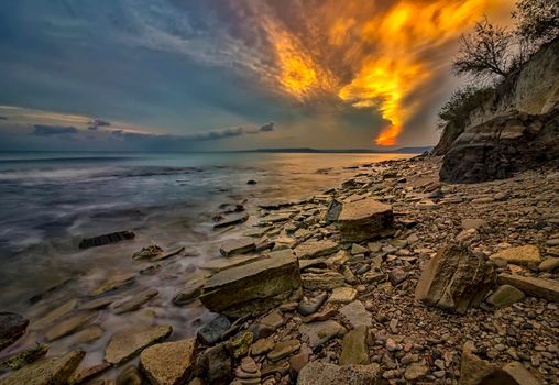 Magnificent sunset view like fire in the sky from the rocky Black sea coast, Bulgaria