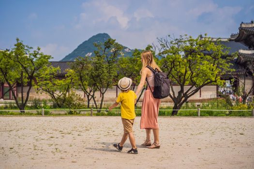 Mom and son tourists in Korea. Gyeongbokgung Palace grounds in Seoul, South Korea. Travel to Korea concept. Traveling with children concept