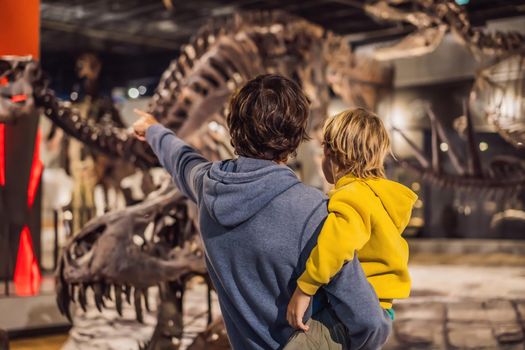 08.29.2019 Seoul, Korea: Dad and boy watching dinosaur skeleton in museum
