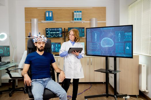 Doctor following a male patient during brain scan procedures