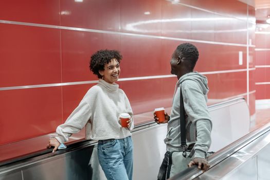 couple in love with a takeaway coffee is flirting on the subway