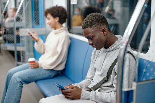 young people with smartphones traveling in the subway .