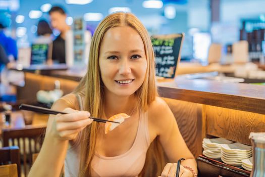 Young woman eating sushi in a cafe