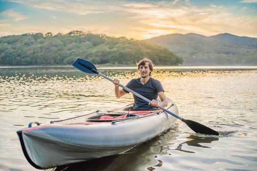 Summer Travel Kayaking. Man Paddling Transparent Canoe Kayak, Enjoying Recreational Sporting Activity. Male Canoeing With Paddle, Exploring Sea On Vacation. Rowing Water Sports