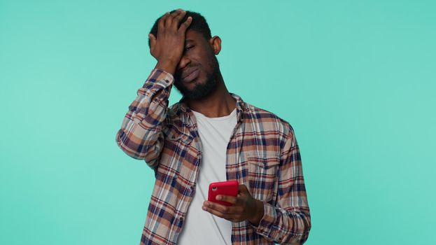 African american man use mobile phone browsing, loses, sudden lottery results, bad fortune, loss