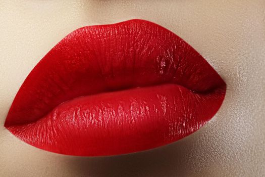 Beautiful female Lips. Sweet Kiss with red lipstick. Lip Make-up on macro shoot. Hot fashion lip makeup